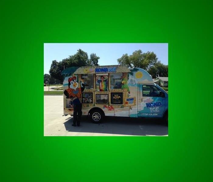 The Kona Ice truck parked in front of a local agents office